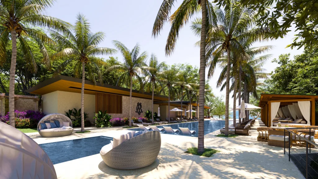 La terraza de piscina del Ocean Club en Cantomar, a la sombra de palmeras y cabañas